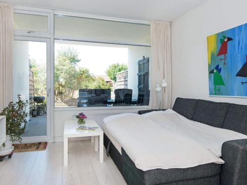 a bedroom with a bed and a large window at 4 person holiday home in Glesborg in Glesborg