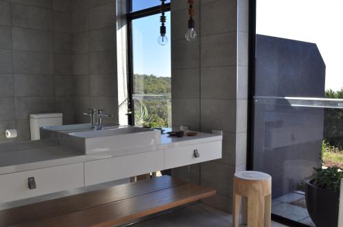 a bathroom with a sink and a window at Blue Range Estate Villas in Rosebud