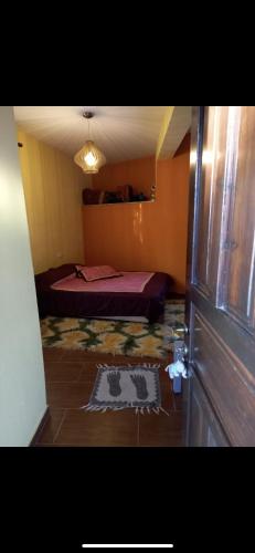 a bedroom with a bed in the corner of a room at Καραναστασης in Elassona
