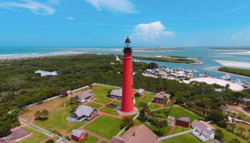 an aerial view of a red lighthouse next to the ocean at Cozy Studio Suite Near Beach W Kitchenette #3 in Daytona Beach Shores