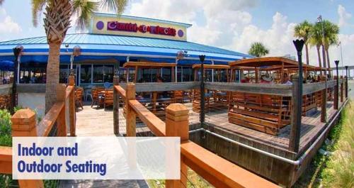 a building with a restaurant with a outdoor seating at Cozy Studio Suite Near Beach W Kitchenette #11 in Daytona Beach Shores