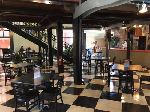 a restaurant with tables and chairs and a checkered floor at Cozy Studio Suite Near Beach w Kitchenette #5 in Daytona Beach Shores