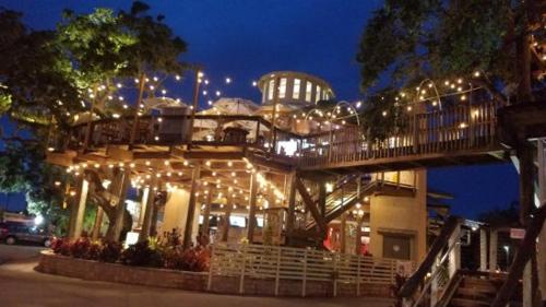 a building with a deck with lights on it at Cozy Studio Suite Near Beach W Kitchenette #11 in Daytona Beach Shores