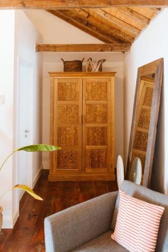 a living room with a couch and a wooden cabinet at Dreamsea Boutique Experience in Moya