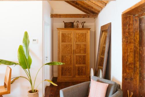 a living room with a chair and a cabinet at Dreamsea Boutique Experience in Moya