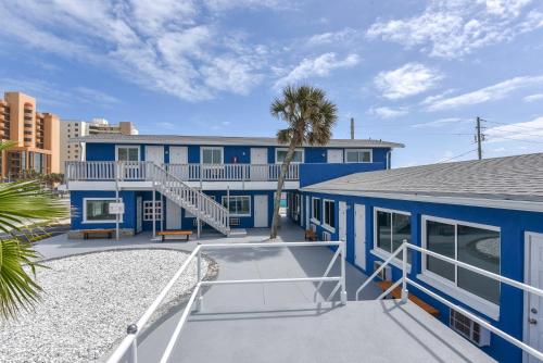 a blue building with a staircase in front of it at Cozy Studio Suite Near Beach W Kitchenette #11 in Daytona Beach Shores