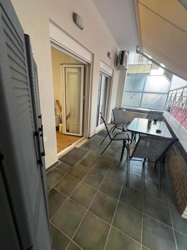 a balcony with a table and chairs in a room at La Maison Luxury in Lamía