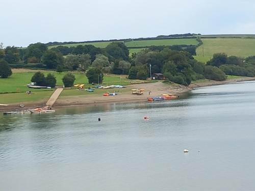 a view of a body of water with a beach at Foxgloves in Brompton Regis