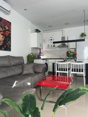 a living room with a couch and a red table at Apartamento Royal Gines I a 10 minutos de Sevilla in Ginés