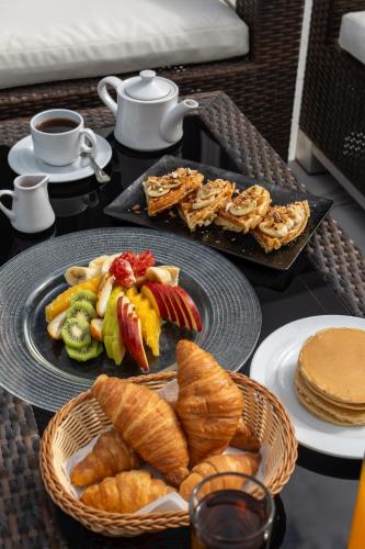 a table with two plates of bread and pastries at Porto Marina Resort & Spa Al Alamein in El Alamein
