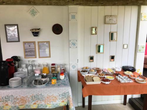 a room with a buffet of food on a table at Pousada Amaravida in Praia do Rosa