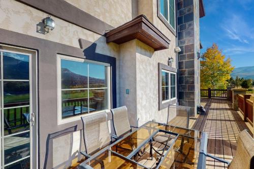 a balcony with two chairs and a glass table at Black Bear Lodge in Eagle
