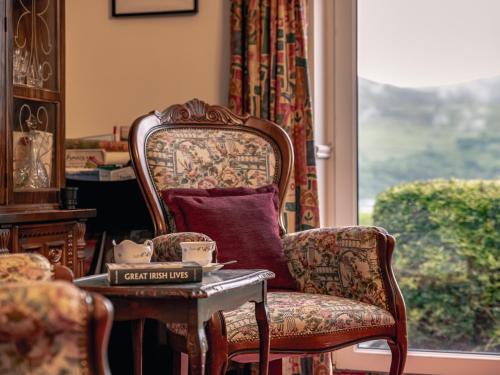 a room with a chair and a table and a window at Large 5 bedroom home to sleep 10 people with wonderful sea views in Kenmare