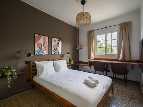 a bedroom with a bed and a desk and a window at Samar Retreat in Teror