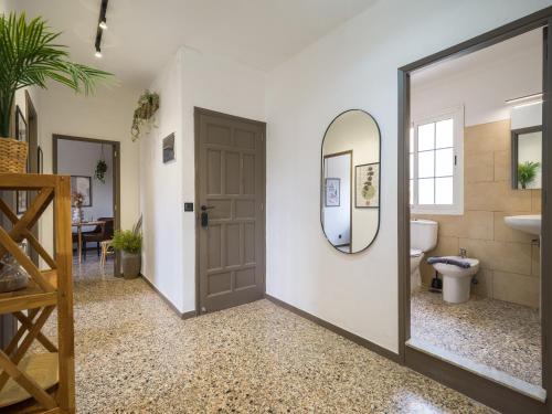 a bathroom with a door and a mirror at Samar Retreat in Teror