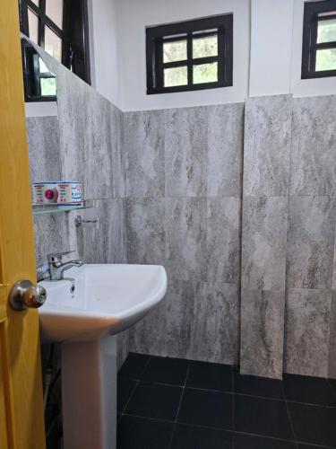 a bathroom with a sink and a shower at Chez Allen in Nuwara Eliya