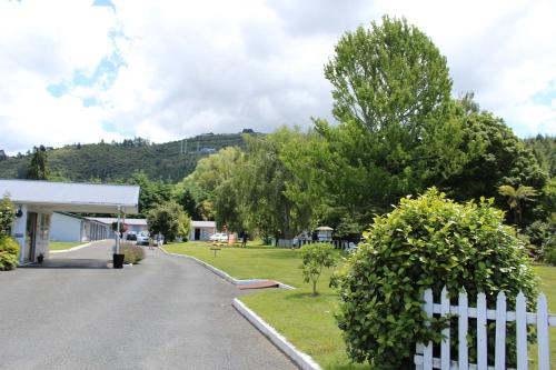 a white fence in front of a gas station at Fairy Springs Motel in Rotorua