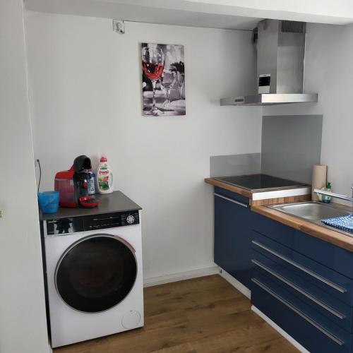 a kitchen with a washing machine and a sink at Bel - Self Check-Inn in Eggenfelden