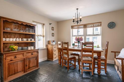 a kitchen with a dining room table and chairs at 3 bedroom pet friendly home in the heart of Kenmare town in Kenmare