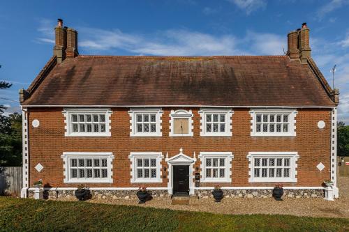 a large red brick house with a brown roof at Catton Old Hall Norwich in Norwich