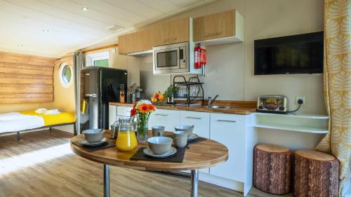 a kitchen with a table in a caravan at Newby Bridge Country Caravan Park in Newby Bridge