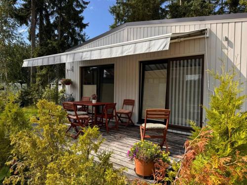 a tiny house with a table and chairs on a deck at Villa Vlada in Saulkrasti