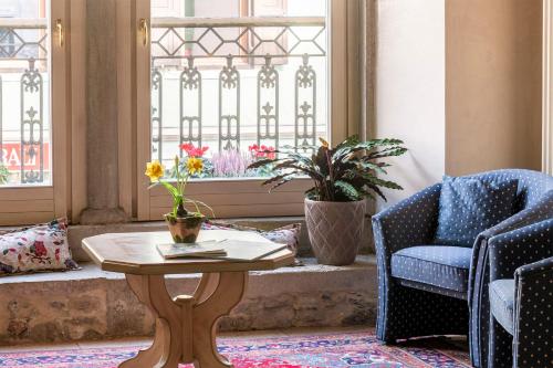 a room with a table and chairs and a window at Hotel Relais Orsingher in Fiera di Primiero
