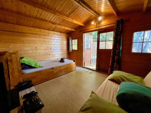 a room with a bed in a wooden cabin at Bubble Dome Village in Saint-Joseph