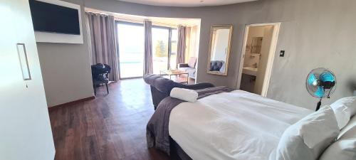 a hotel room with a bed and a large window at Beach House Margate in Margate