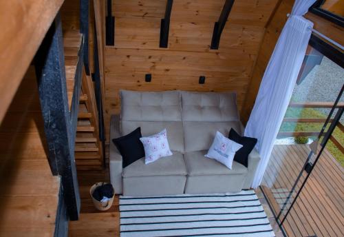 an overhead view of a couch with pillows on it at Cabanas Refúgio do Vale in Bento Gonçalves