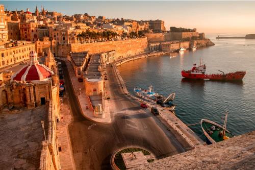a view of a river with a boat in the water at Authentic Maltese Boutique Holiday Home with Rooftop Pool - Moon Townhouse in Cospicua