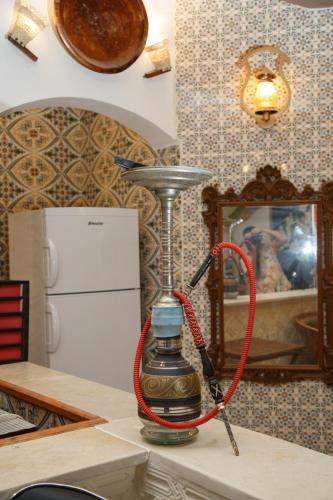 a hookah on a table in a kitchen at Dar Amazigh in Tozeur