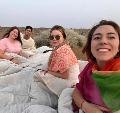 a group of three women sitting on blankets at The Desert Resort Jaisalmer in Jaisalmer