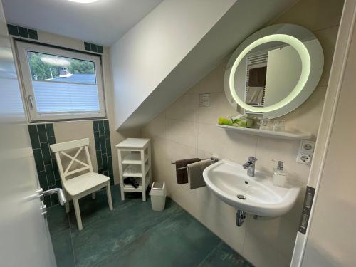 a bathroom with a sink and a mirror at Hotel Garni Maaß in Braubach
