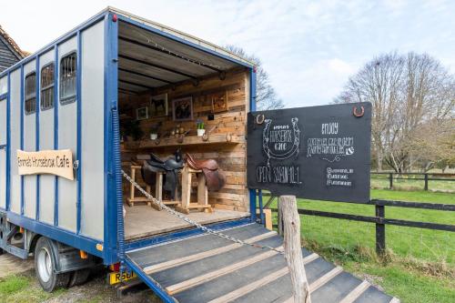 a blue truck is parked in a field at Beautiful Yurt with stunning South Downs views in Graffham