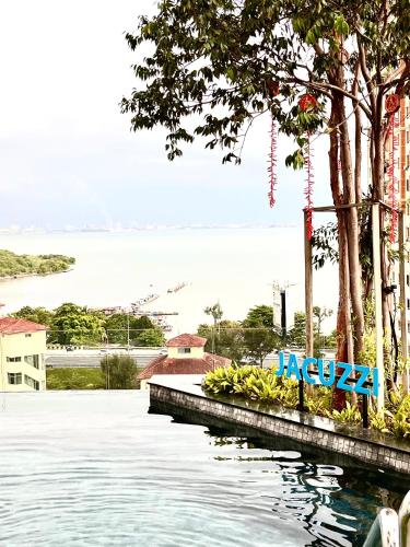 a view of a body of water with trees at Georgetown Childroom Seaview & Cityview Infinity Pool with 2 Carpark in Jelutong