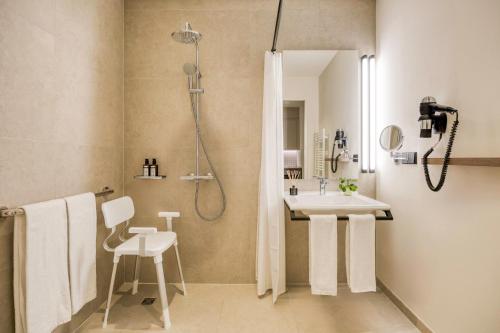 a bathroom with a shower and a sink and a toilet at Citadines Kurfürstendamm Berlin in Berlin