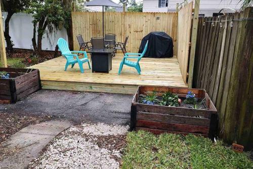 two chairs and a table on a wooden deck at Tuscawilla B -Beautiful 3 bedroom apt Historic Ocala 1891 in Ocala