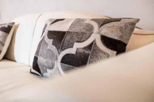 a pillow sitting on top of a bed at Le 1615 - Luxe et Spa in Colmar