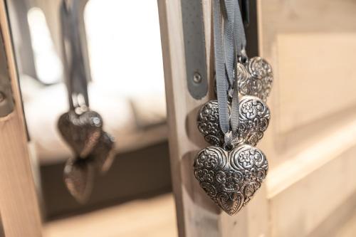 a pair of hearts are hanging on a door at Le 1615 - Luxe et Spa in Colmar