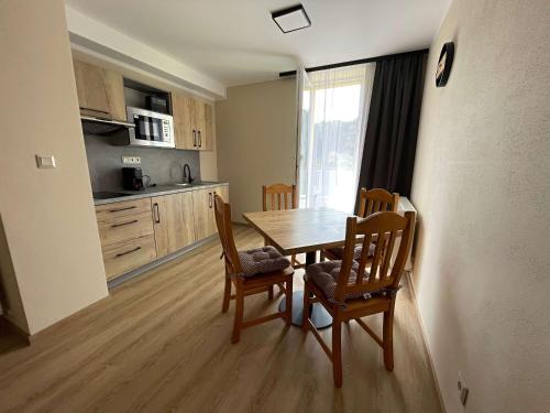 a kitchen and dining room with a table and chairs at Apartmány U Bernharda in Vítkov
