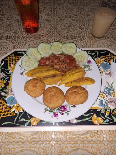 a plate of food with beans and vegetables on a table at Kingston Airport bed and breakfast in Kingston