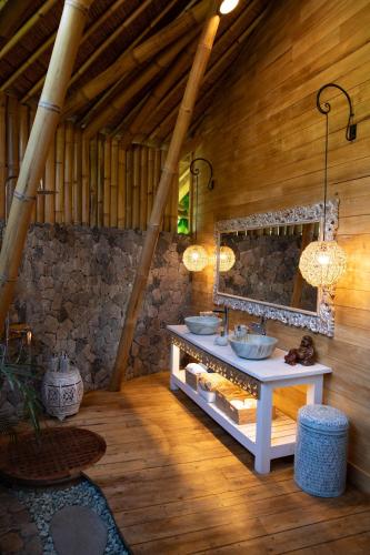 a bathroom with a sink and a mirror at Villas Bukit Lipah in Amed