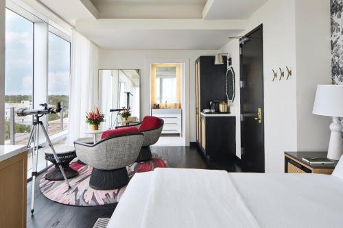 a bedroom with a table and two chairs and a window at La Concha Key West, Autograph Collection in Key West