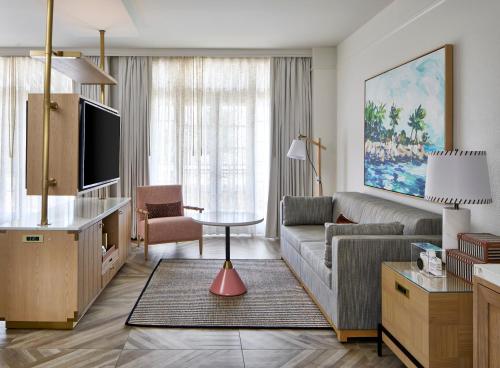 a living room with a couch and a table at La Concha Key West, Autograph Collection in Key West