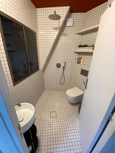 a bathroom with a toilet and a sink at Studio Victoria - Centre de Paris in Paris