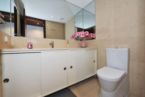 a bathroom with a toilet and a sink and a mirror at Amazing Sea View in Cascais