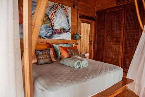a bunk bed with pillows on it in a room at Villas Bukit Lipah in Amed