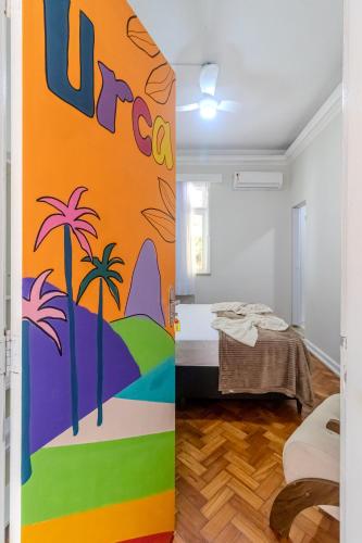 a room with a mural of a beach and palm trees at Maroca RIO in Rio de Janeiro