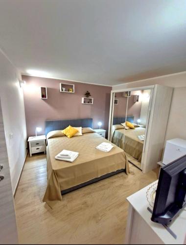 a hotel room with two beds and a television at Medea in Syracuse